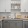 ontemporary kitchen at Momentum Blanding Apartments with stainless steel appliances, open shelving, and sleek white and gray cabinetry.