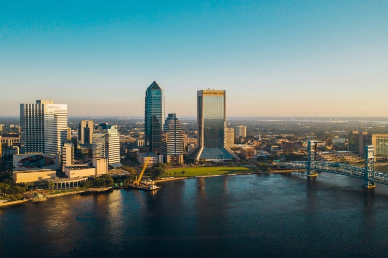 a city skyline with a bridge and a river