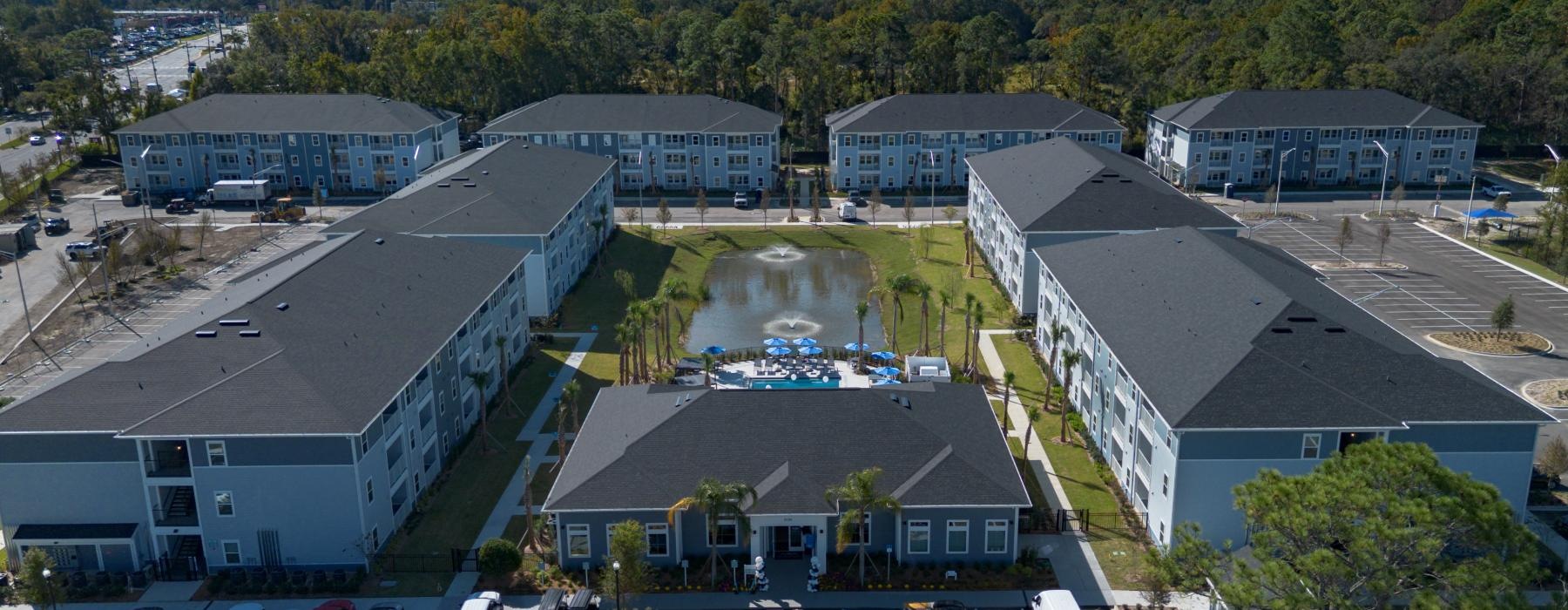 a high angle view of buildings and a pond